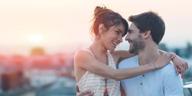 Dating over 30 symbolized by a couplewho smile at each other and embrace