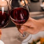 Couple on a dating cheering's with red wine